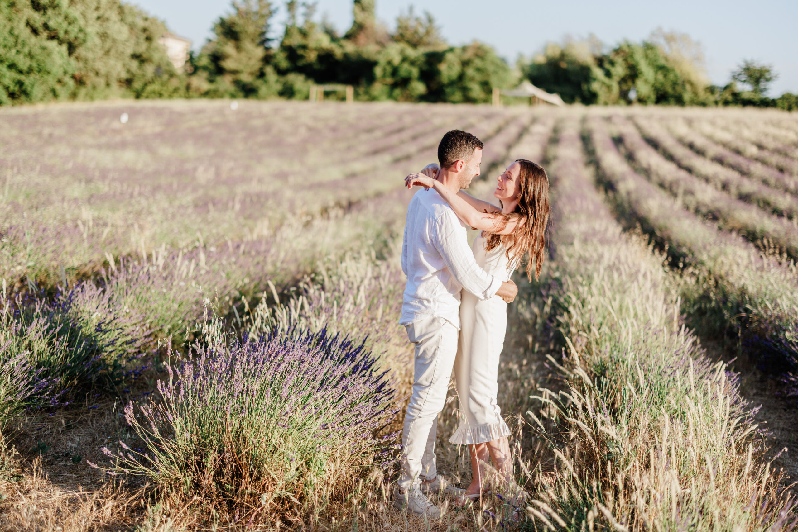 Home Couple hugging in lavender fields in Provence during romantic sunset wedding couple session photoshoot